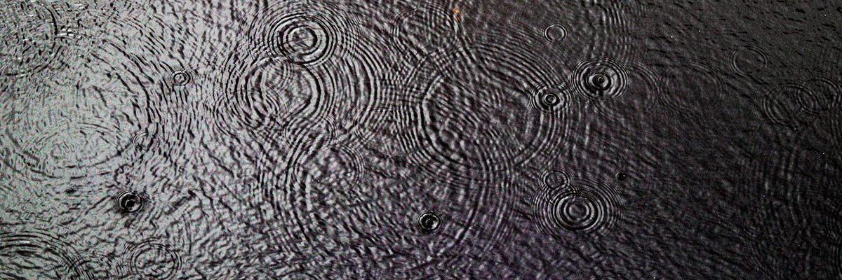 Panoramic view of serene light patterns on black surface